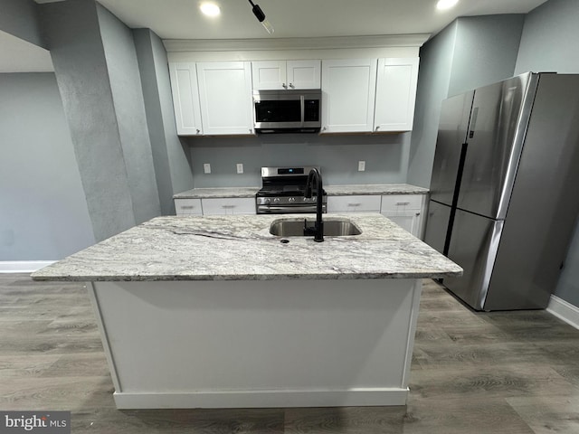 kitchen featuring white cabinetry, appliances with stainless steel finishes, and light stone counters