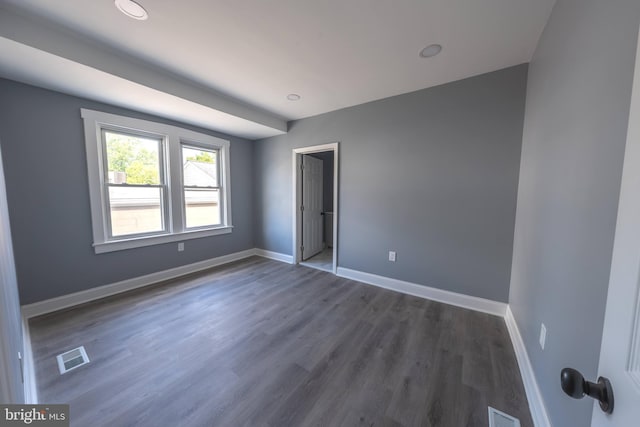 unfurnished bedroom featuring dark hardwood / wood-style flooring