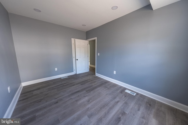 unfurnished bedroom with dark hardwood / wood-style floors