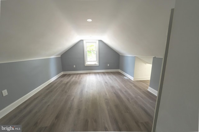 bonus room featuring dark hardwood / wood-style flooring and vaulted ceiling