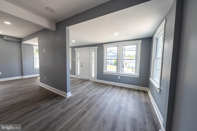 foyer with dark hardwood / wood-style flooring and beamed ceiling