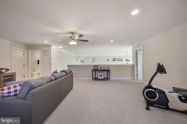 carpeted living room with ceiling fan and wine cooler