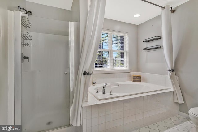 full bathroom featuring a shower stall, a garden tub, tile patterned floors, and toilet