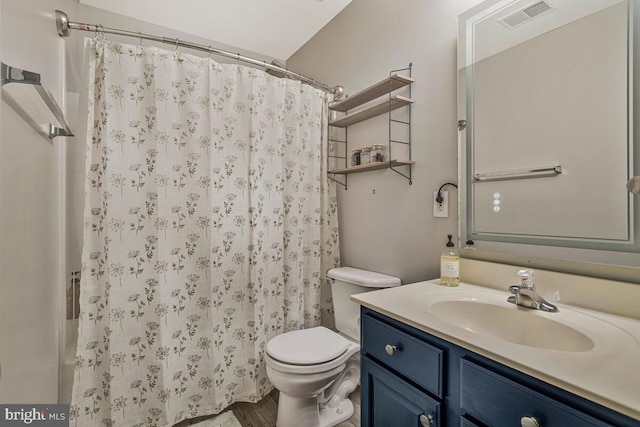 bathroom with visible vents, toilet, vanity, and a shower with curtain