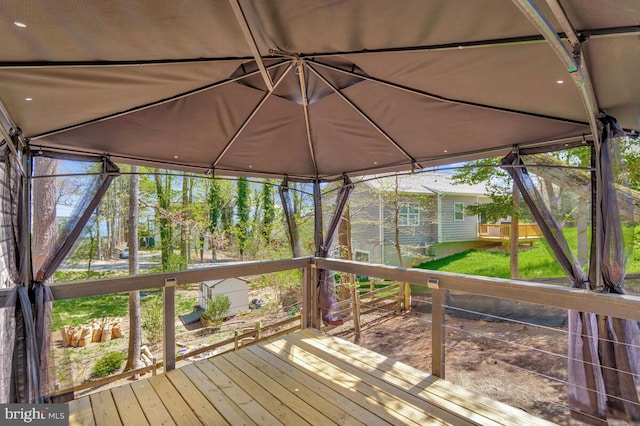 wooden terrace featuring a lawn