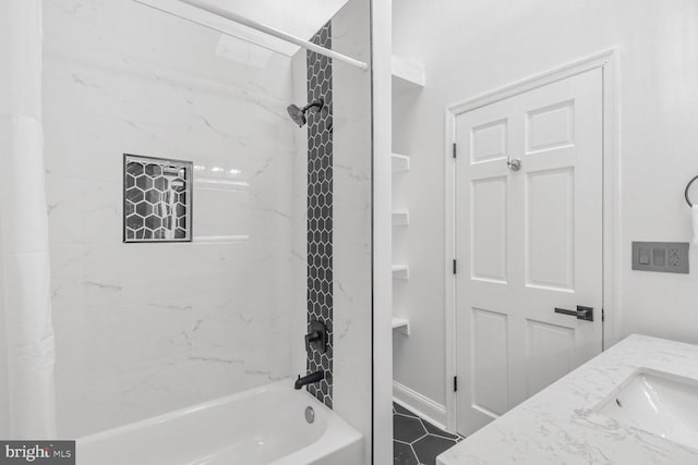 bathroom featuring vanity, tiled shower / bath, and tile patterned floors