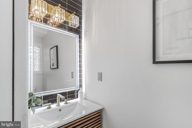 bathroom featuring decorative backsplash, vanity, and toilet