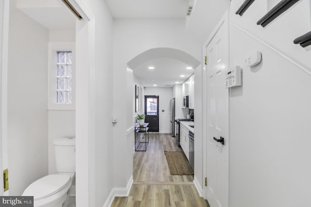 bathroom with toilet and wood-type flooring