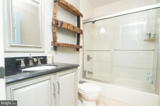 full bath with toilet, tile patterned flooring, enclosed tub / shower combo, and vanity