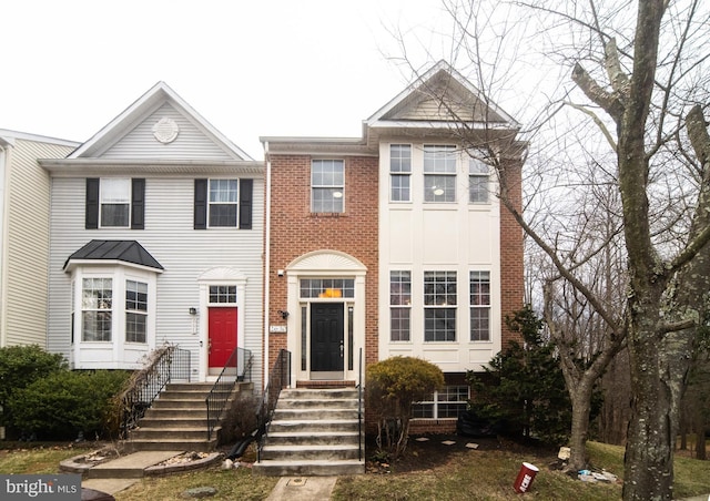 view of property with entry steps and brick siding