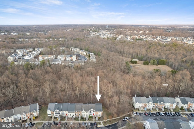 birds eye view of property featuring a forest view and a residential view