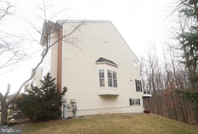 view of property exterior with a yard