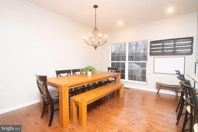 dining space featuring recessed lighting, wood-type flooring, visible vents, a chandelier, and baseboards