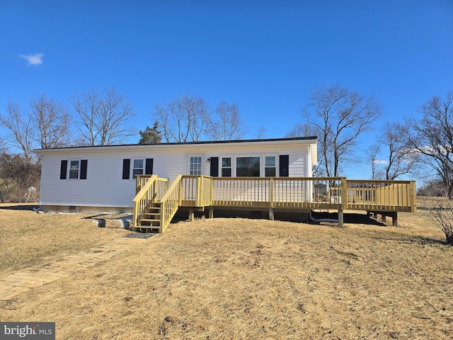 view of front of house with a wooden deck and a front yard