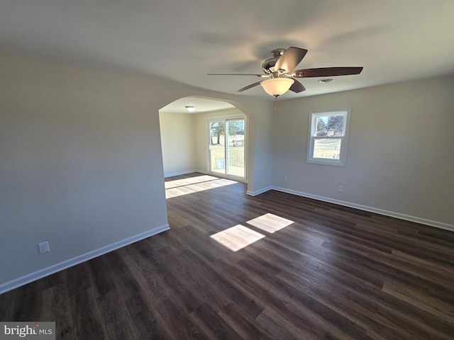 empty room with dark wood-type flooring and ceiling fan