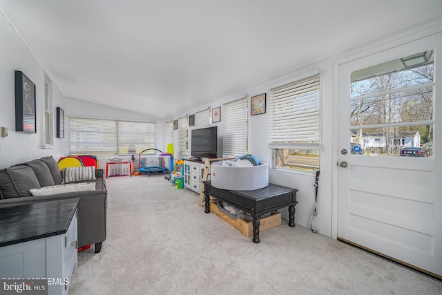 living room with lofted ceiling and light colored carpet