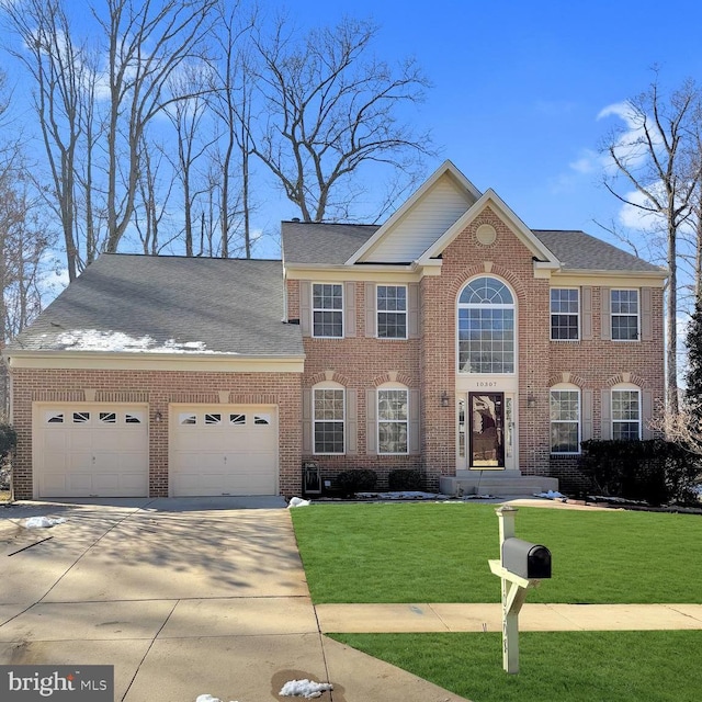 colonial house featuring a garage and a front lawn