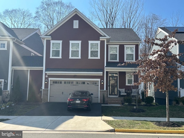 view of front of property with driveway, a garage, and brick siding