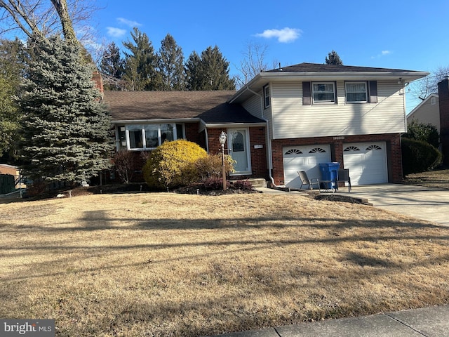 split level home with a front lawn and a garage