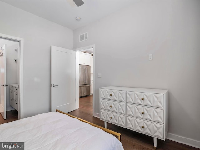 bedroom with dark hardwood / wood-style floors and high end fridge