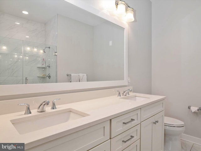 bathroom featuring vanity, toilet, and walk in shower