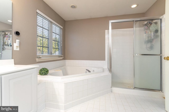 bathroom featuring a stall shower, tile patterned floors, vanity, a bath, and recessed lighting