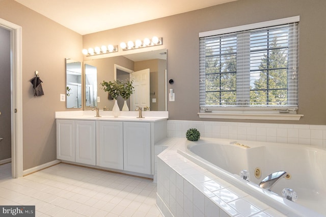 full bath featuring double vanity, baseboards, tile patterned floors, a jetted tub, and a sink