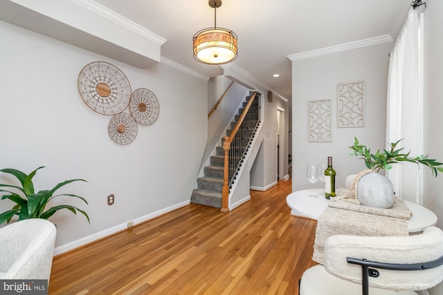 living area with light wood finished floors, baseboards, stairway, and crown molding