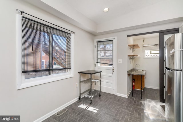 dining space featuring brick floor, recessed lighting, visible vents, and baseboards