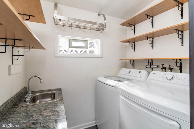 laundry area featuring laundry area, a sink, and separate washer and dryer