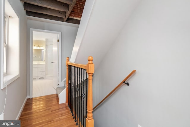 staircase with wood finished floors and baseboards