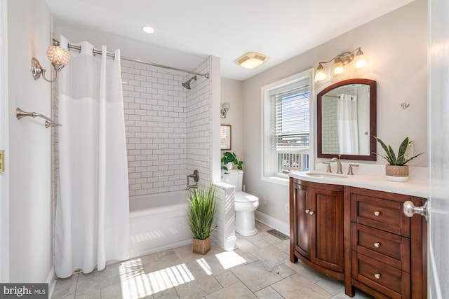 full bathroom with baseboards, visible vents, toilet, shower / bath combo with shower curtain, and vanity