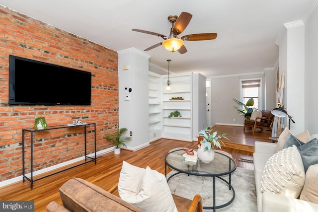 living room featuring light wood-style floors, baseboards, and ornamental molding