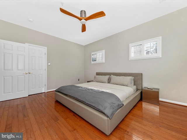 bedroom with ceiling fan and light hardwood / wood-style floors