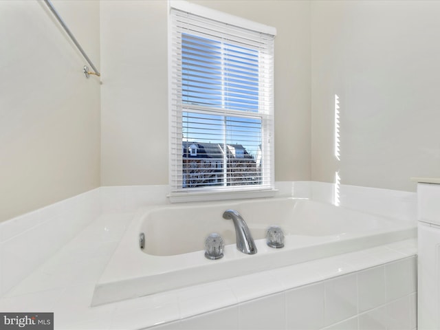 bathroom featuring a relaxing tiled tub