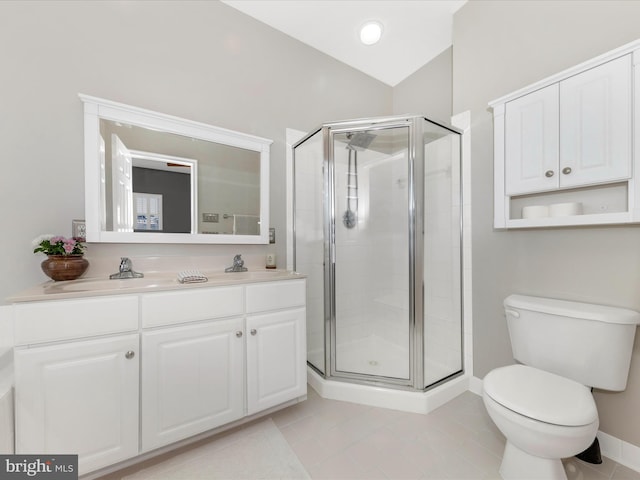 bathroom featuring vanity, a shower with door, and toilet