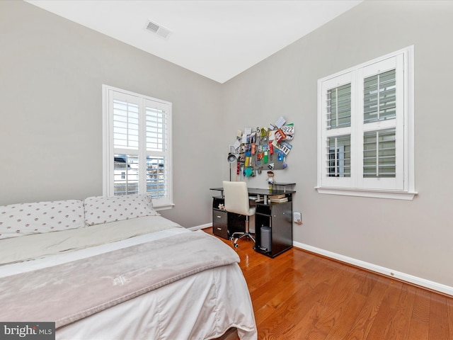 bedroom with hardwood / wood-style flooring