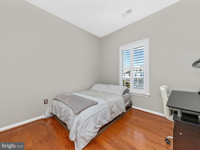 bedroom with hardwood / wood-style floors