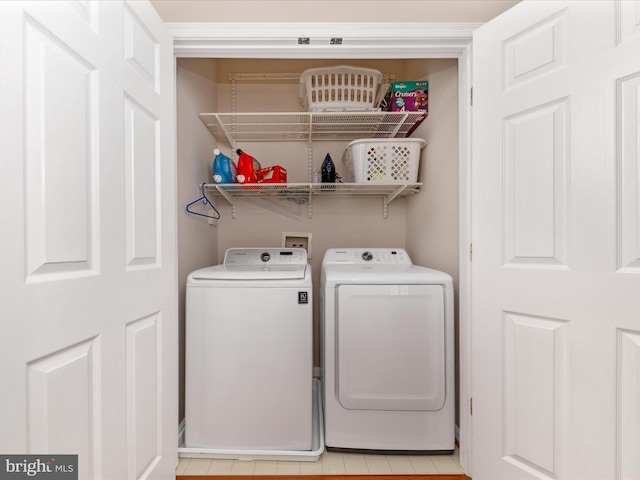 clothes washing area with washing machine and clothes dryer