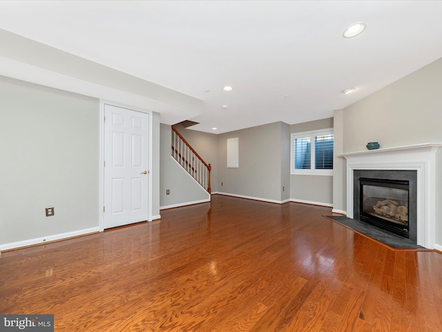 unfurnished living room with wood-type flooring