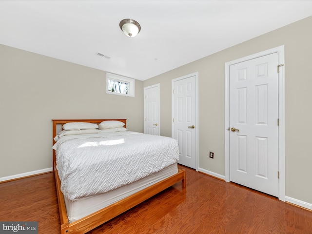 bedroom with wood-type flooring