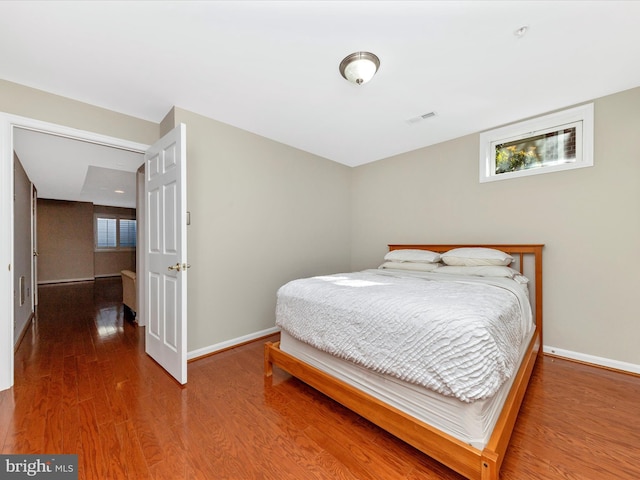 bedroom with wood-type flooring