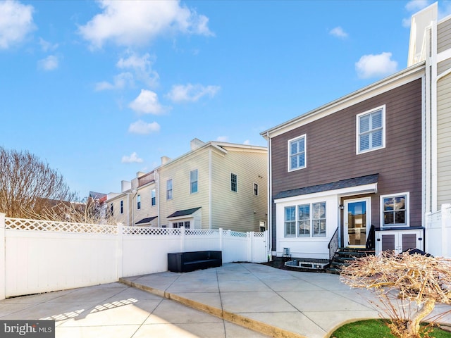 rear view of property featuring a patio