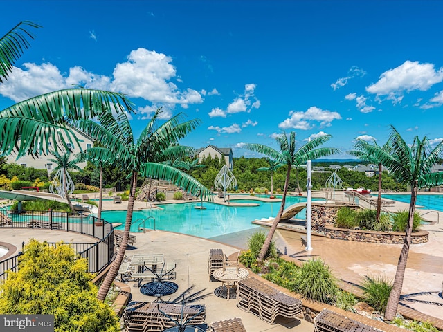 view of pool featuring a patio and a jacuzzi