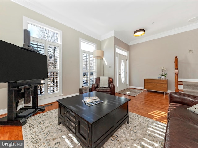 living room featuring light hardwood / wood-style flooring and ornamental molding