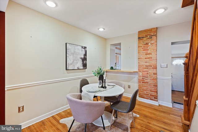 dining area with light wood finished floors, baseboards, and recessed lighting