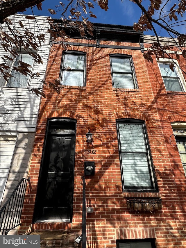 exterior space with brick siding