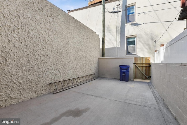 view of patio featuring a gate and fence