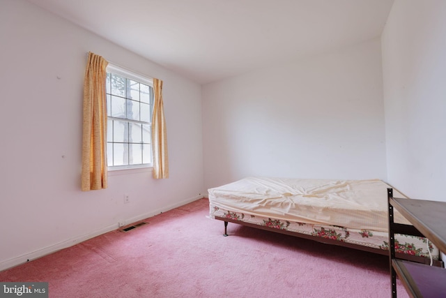 bedroom featuring carpet, visible vents, and baseboards