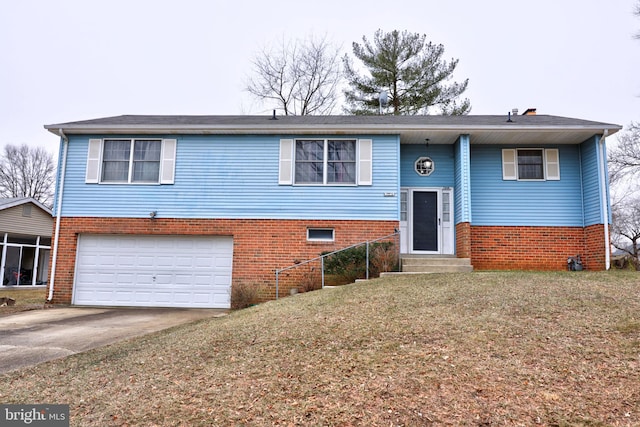 split foyer home featuring brick siding, concrete driveway, an attached garage, entry steps, and a front yard